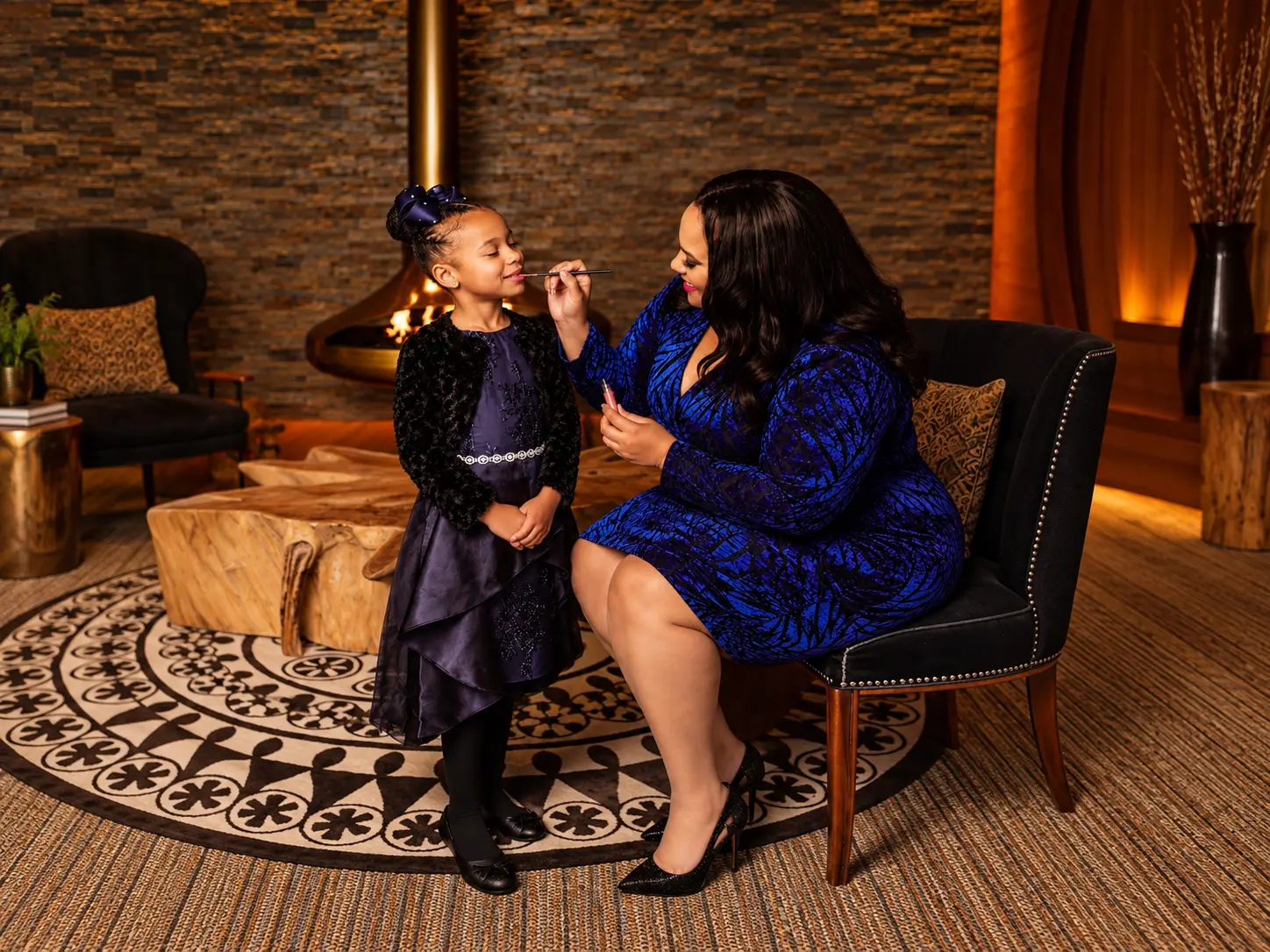 Autumn Lee founder applying lip gloss to her daughter